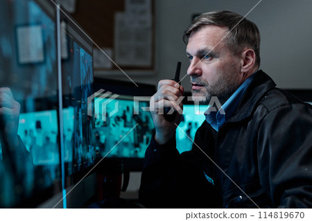 Using walkie-talkie in front of computer 114819670