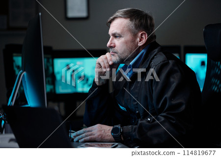 Security guard watching CCTV video Security guard watching CCTV video 114819677