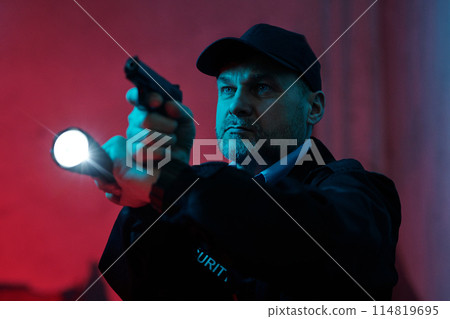 Security guard with flashlight and gun Security guard with flashlight and gun 114819695