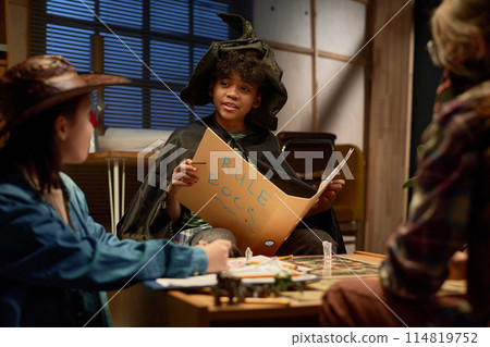 Boy holding open book of game rules 114819752