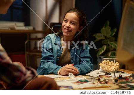 Girl chatting with friend during game 114819776