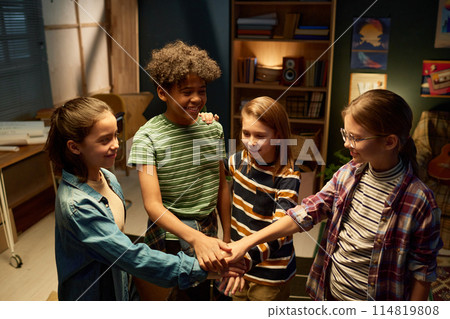 Happy kids making pile of hands Happy kids making pile of hands 114819808