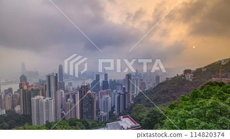 The famous view of Hong Kong from Victoria Peak timelapse. Taken at sunrise while the sun climbs over Kowloon Bay. 114820374