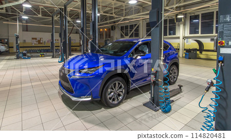 Professional car mechanics checking under hood in auto repair service timelapse hyperlapse. 114820481