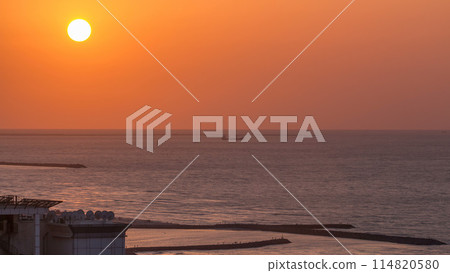 Sunset in Ajman aerial view from rooftop timelapse. United Arab Emirates. 114820580