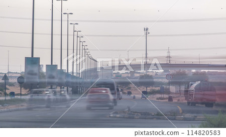 Highway roads with traffic timelapse in a big city from Ajman to Dubai at evening 114820583
