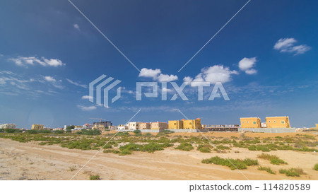Cityscape of Ajman with villa houses ready and under constroction timelapse. United Arab Emirates. Cityscape of Ajman with villa houses ready and under constroction timelapse. United Arab Emirates. 114820589