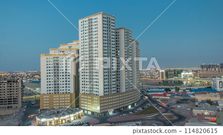 Cityscape with towers in Ajman from rooftop day to night timelapse. United Arab Emirates. 114820615