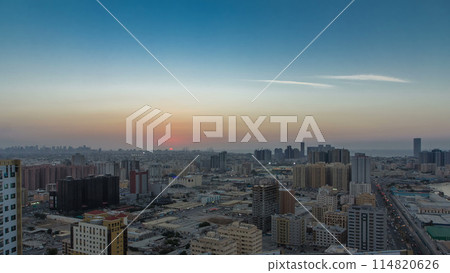 Cityscape of Ajman from rooftop day to night timelapse after sunset. 114820626