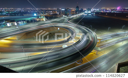 Traffic on a big road junction in Ajman aerial view from rooftop at night timelapse. 114820627