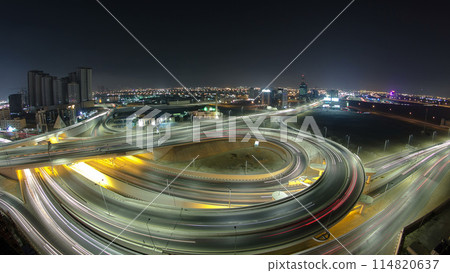 Traffic on a big road junction in Ajman aerial view from rooftop at night timelapse. Traffic on a big road junction in Ajman aerial view from rooftop at night timelapse. 114820637