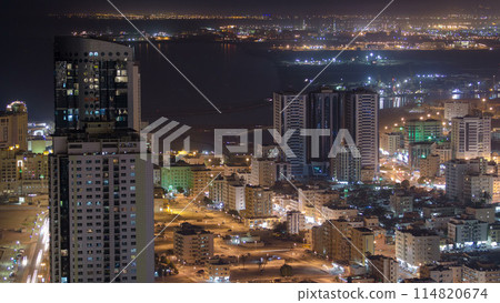 Cityscape of Ajman from rooftop night aerial timelapse 114820674
