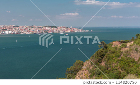 Panorama of Lisbon historical centre aerial timelapse viewed from above the southern margin of the Tagus or Tejo River. 114820750