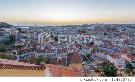 Lisbon panorama after sunset aerial view of city centre with red roofs at autumn day to night timelapse, Portugal Lisbon panorama after sunset aerial view of city centre with red roofs at autumn day to night timelapse, Portugal 114820783