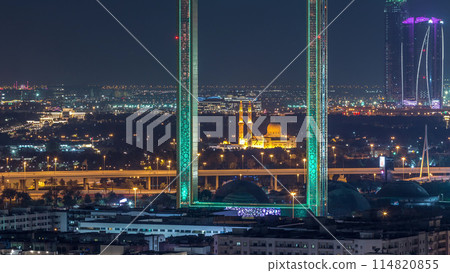 Dubai Frame with Zabeel Masjid mosque illuminated at night timelapse. Dubai Frame with Zabeel Masjid mosque illuminated at night timelapse. 114820855