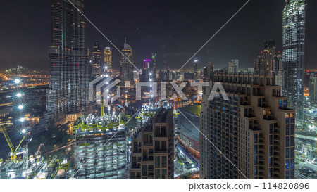 Panoramic skyline view of Dubai downtown before sunrise with mall, fountains and skyscrapers aerial night to day timelapse 114820896