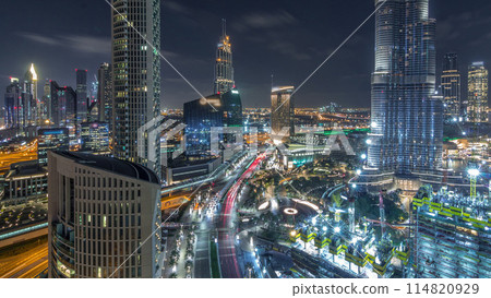 Panoramic skyline view of Dubai downtown with mall, fountains and skyscrapers aerial night timelapse Panoramic skyline view of Dubai downtown with mall, fountains and skyscrapers aerial night timelapse 114820929