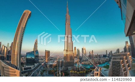 Panoramic skyline view of Dubai downtown after sunset with mall, fountains and skyscrapers aerial day to night timelapse Panoramic skyline view of Dubai downtown after sunset with mall, fountains and skyscrapers aerial day to night timelapse 114820960