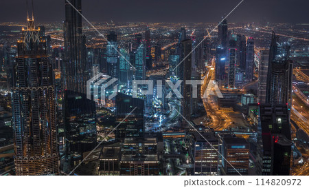 Dubai Downtown skyline futuristic cityscape with many skyscrapers and Burj Khalifa aerial night to day timelapse. Dubai Downtown skyline futuristic cityscape with many skyscrapers and Burj Khalifa aerial night to day timelapse. 114820972