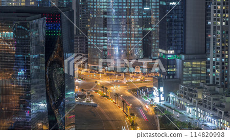 Top view city traffic on a crossroad in Dubai Business bay night timelapse. 114820998