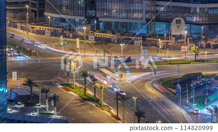 Top view city traffic on a crossroad in Dubai Business bay night timelapse. 114820999
