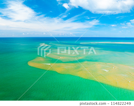 Aerial view of a blue sea surface water texture background,Sun reflections over ocean, Aerial flying drone view Waves water surface texture on sunny tropical ocean in Phuket island Thailand Aerial view of a blue sea surface water texture background,Sun reflections over ocean, Aerial flying drone view Waves water surface texture on sunny tropical ocean in Phuket island Thailand 114822249