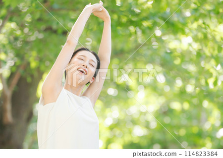 A woman relaxing in the fresh greenery 114823384