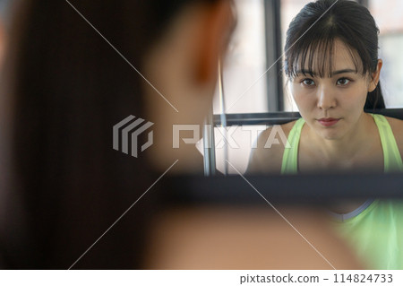 Young woman training in a sports gym Young woman training in a sports gym 114824733