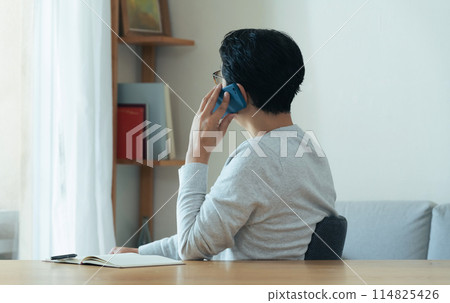 Middle-aged man talking on smartphone 114825426