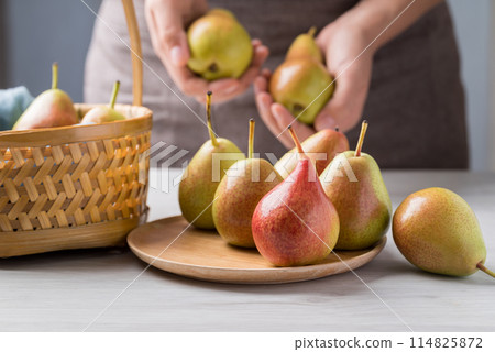 Fresh pear fruit with hand preparing for eating Fresh pear fruit with hand preparing for eating 114825872
