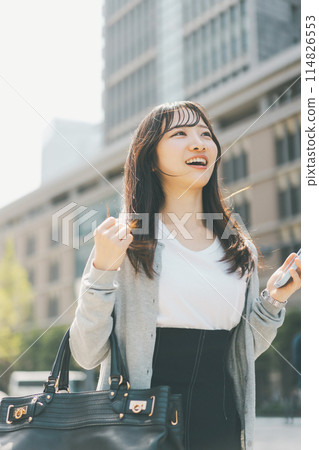 A businesswoman commuting to work in casual clothes 114826553