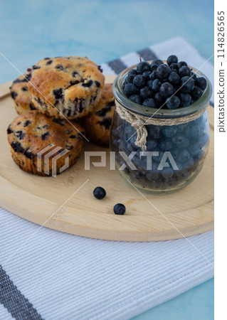 Homemade baked blueberry muffins with fresh harvested blackberries in glass jar. Tasty pastry sweet cupcake dessert. Berry pie cupcakes with organic berries. Gluten free healthcare recipe from Homemade baked blueberry muffins with fresh harvested blackberries in glass jar. Tasty pastry sweet cupcake dessert. Berry pie cupcakes with organic berries. Gluten free healthcare recipe from 114826565