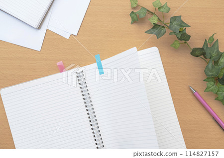 Turning the page. Notebook on the table. Notebook and documents on the desk. 114827157