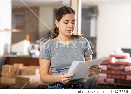 Female architect checking documents in construction site Female architect checking documents in construction site 114827886