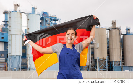 Happy young woman holds the national flag of Germany Happy young woman holds the national flag of Germany 114828063