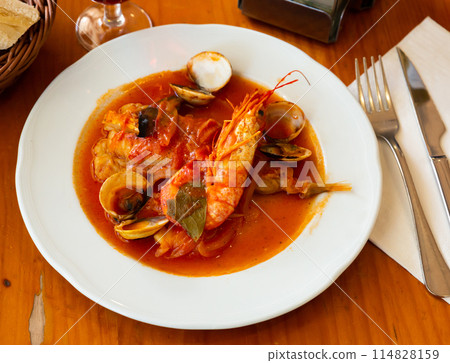 Tail of monkfish with shellfish, prawns Tail of monkfish with shellfish, prawns 114828159
