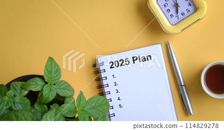 Note book with 2025 plans text. New year resolutions and plan. 114829278