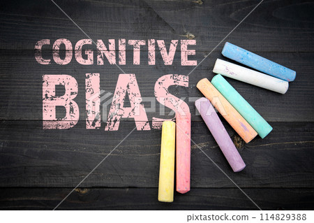 Cognitive Bias. Text and pieces of chalk on a dark wood texture background Cognitive Bias. Text and pieces of chalk on a dark wood texture background 114829388