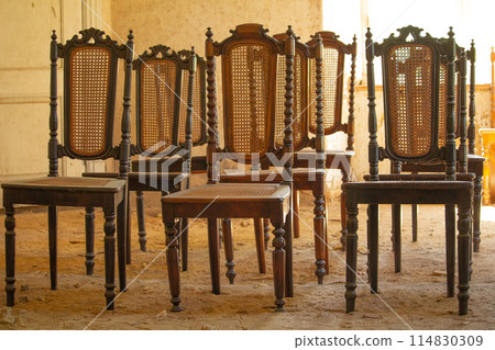 Old vintage wooden chairs in old house. Old vintage wooden chairs in old house. 114830309