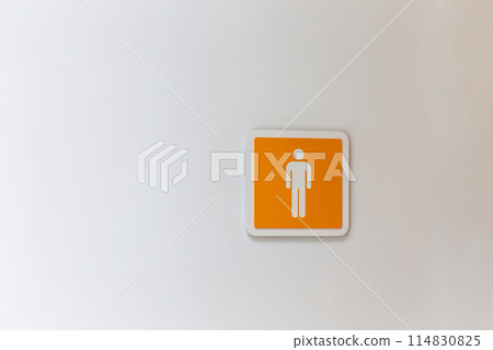 Orange male or man toilet sign on the white wall. copy space background 114830825