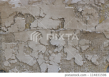 cheap plaster peeled off, revealing mesh layer 114831506