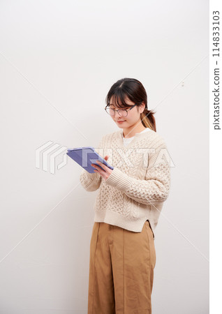 A woman who operates a tablet A woman who operates a tablet 114833103