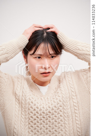 Woman holding her head, white background, worried, thinking Woman holding her head, white background, worried, thinking 114833236