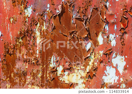 Closeup of rusty metal with peeling brown paint 114833914