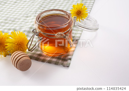 Dandelion honey and fresh flowers. Close up Dandelion honey and fresh flowers. Close up 114835424