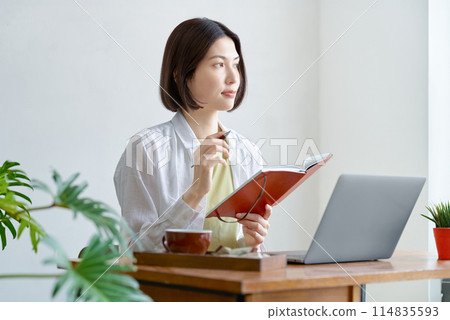 Young woman operating a personal computer in the room Young woman operating a personal computer in the room 114835593