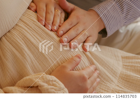 A couple stroking their baby 114835703