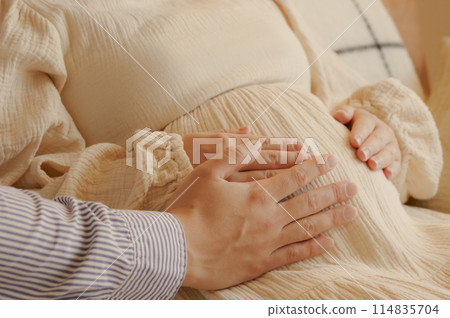 A couple stroking their baby A couple stroking their baby 114835704