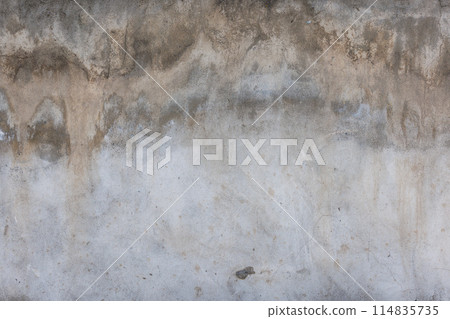 Close up of a grey concrete wall with numerous stains 114835735