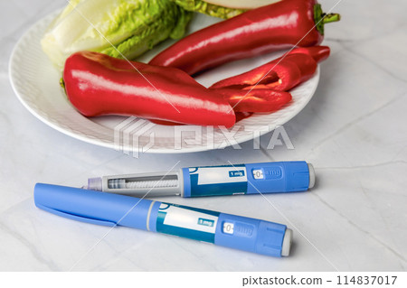 Original Danish Ozempic Insulin injection pen for diabetics and plate with vegetables. 114837017